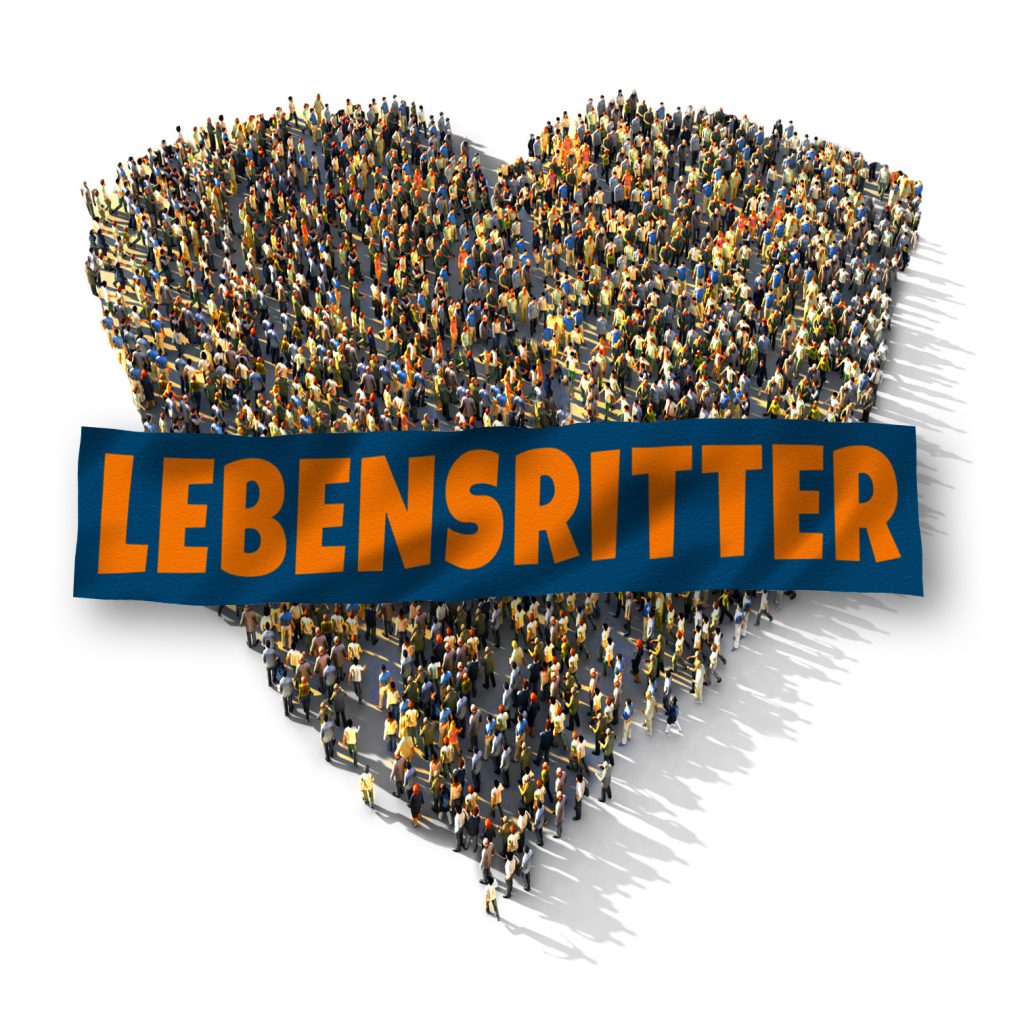 Eine große Gruppe von Menschen steht in einer Formation, die die Form eines Herzens bildet, mit einem Banner mit der Aufschrift „Lebensretter“ auf der Vorderseite.